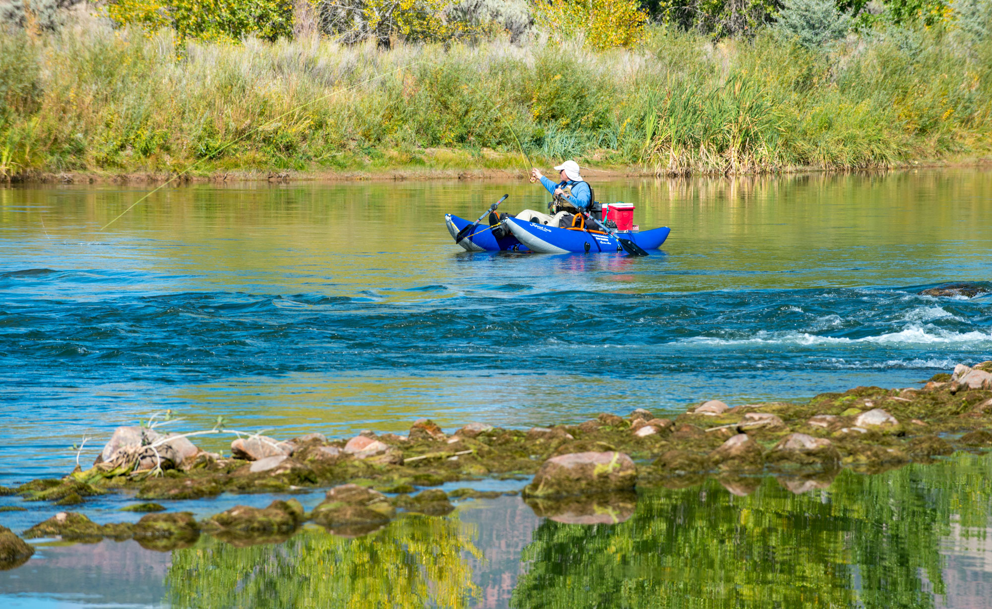 The Green River's calm waters and occasional class III rapids provide a mix of relaxation and excitement